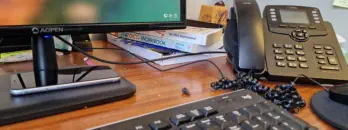 Office desk with phone and computer