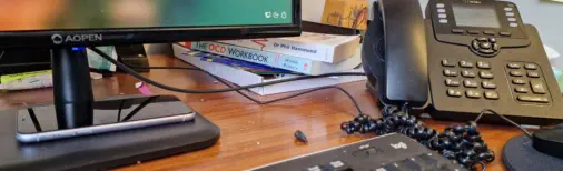 Office desk with phone and computer