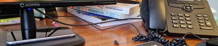 office desk with phone and books